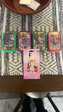 4 One Piece Card Game Tins and 1 Booster pack