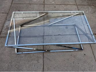 Glass table in excellent condition  47” wide  2” feet side  16” high