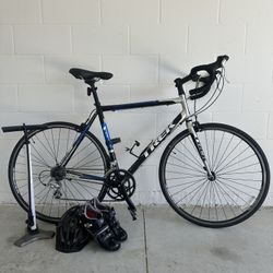 Trek One Series Road Bike with shoes, helmet, and pump