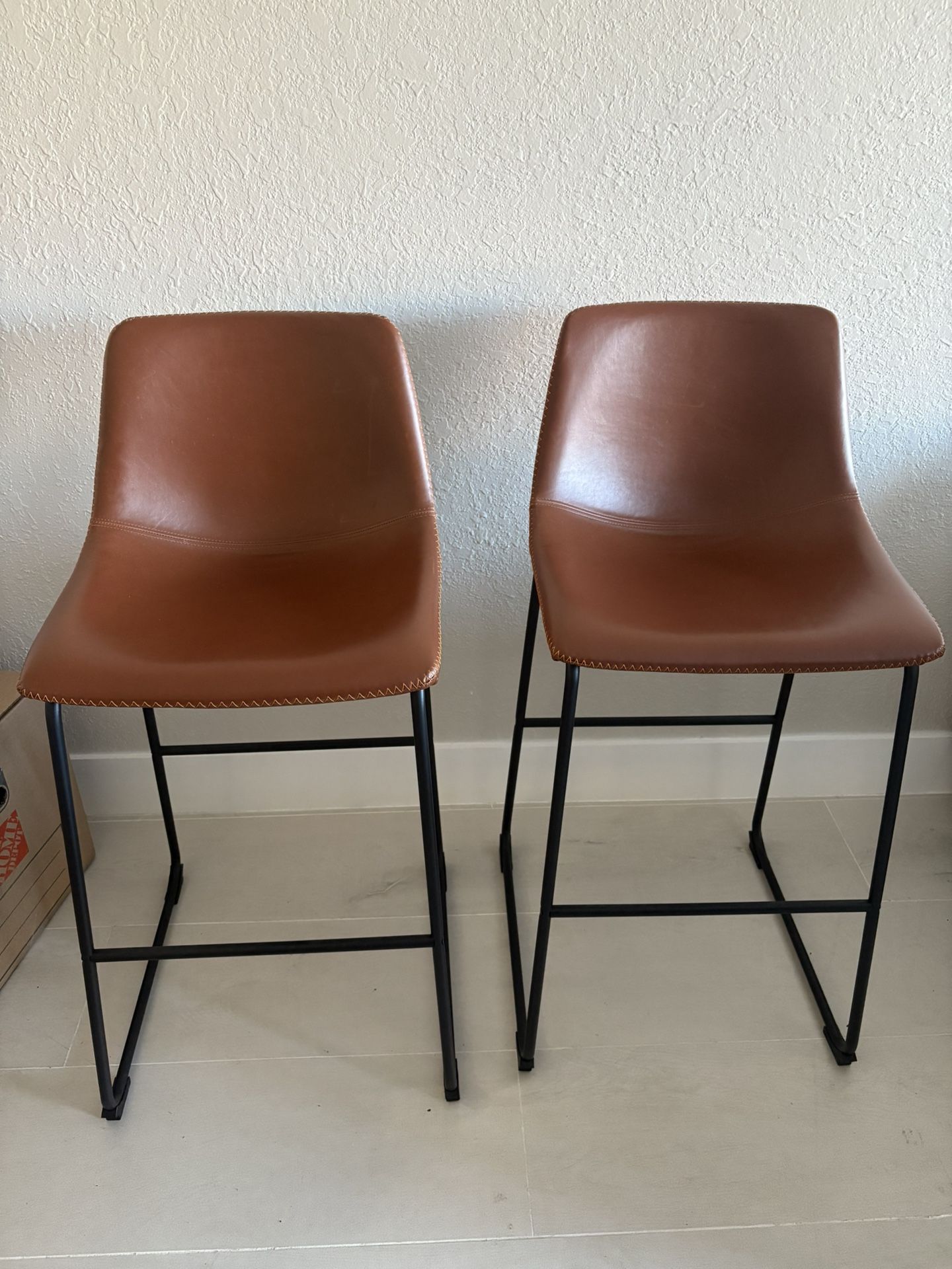 Two whiskey brown stools