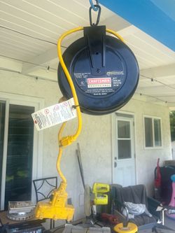 A pair of Craftsman retractable 30ft extension cords