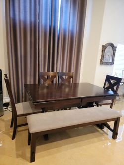 Beautiful table with 4 chairs and bench.