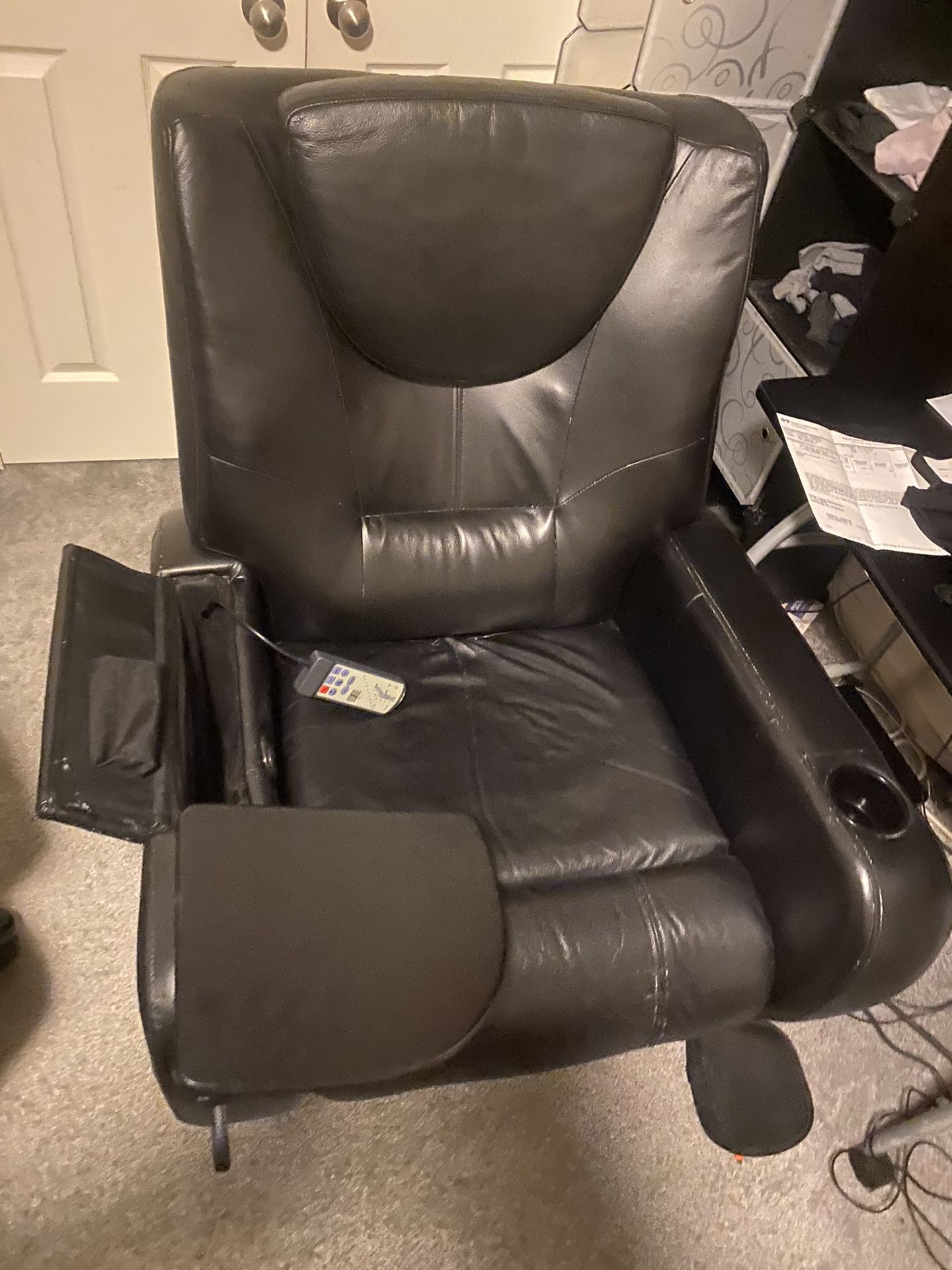 electric recliner massage chair with table and cup holders.