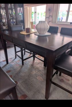 cherry wood bar height dining room table - extendable  with leather trim and 4 - 6 chairs