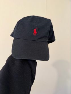 Black polo hat red pony