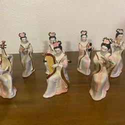 vintage porcelain Chinese statues depicting women in traditional dress playing musical instruments