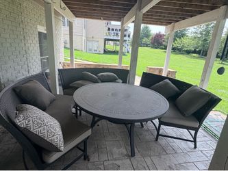 Outdoor dining table with cushions and pillows