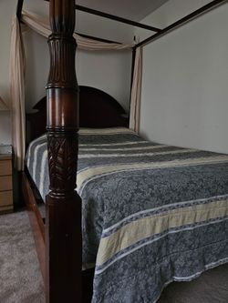 Ornate Bombay company canopy bed with carved mahogany posts. Some scratches. Includes the full-size mattress and boxspring