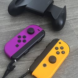 Nintendo Switch Orange and Purple controller with hand grips and straps