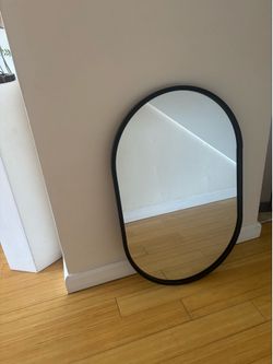 Oval black trim mirror
