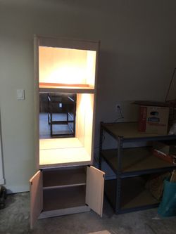 Wooden display cabinet with shelves, mirror and door