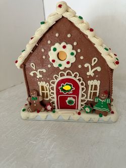 Battery Operated Gingerbread House size 9”tall by 8” wide missing battery cover on the bottom