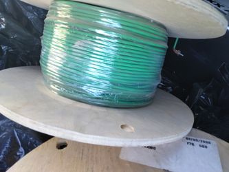 3 wooden spool containing a green, single-conductor 24 AWG Type CL2 power-limited circuit cable, manufactured on March 26, 2009, with a total length o