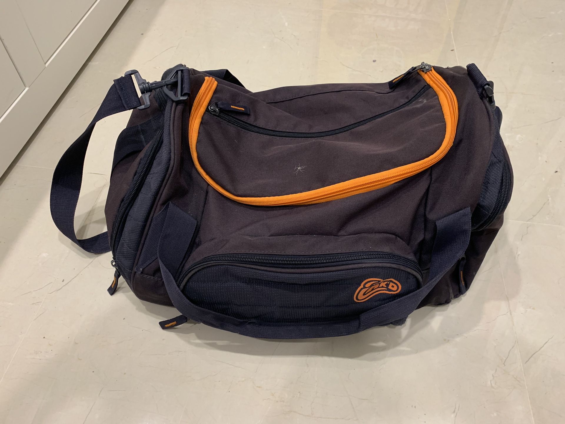 Small orange and blue duffle bag