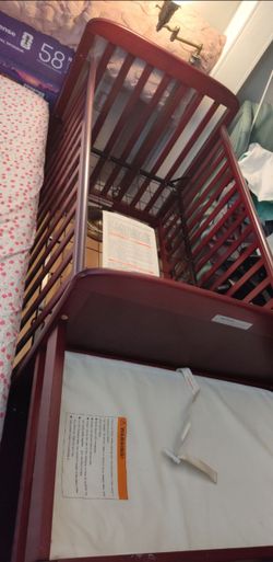 Cherry wood baby convertible crib and changer