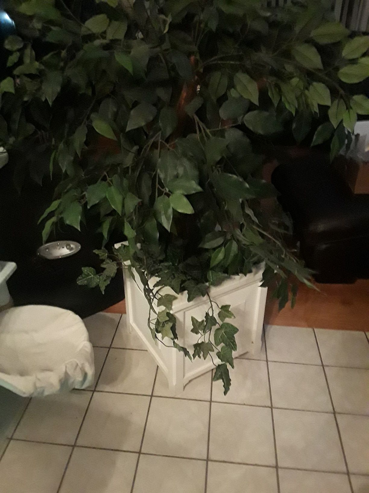 Artificial plant in white wooded pot
