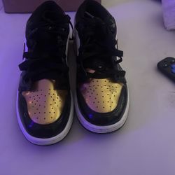Air Jordan 1 Low Gold Toe sneakers. 