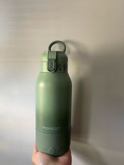 Green Momcozy portable baby bottle warmer for travel