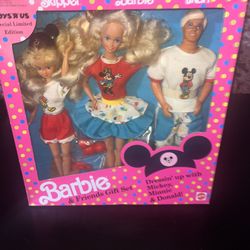 This is a 1991 Disney Barbie and Friends Gift Set featuring Barbie, Ken, and Skipper dolls. 