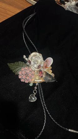 vintage mixed-media bolo tie featuring a large collage pendant.