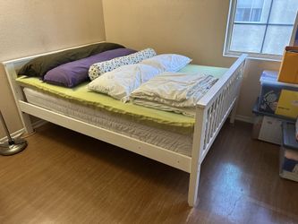 Full bed frame with mattress and topper.