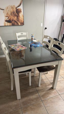 Ashley furniture dining table with glass top and six chairs