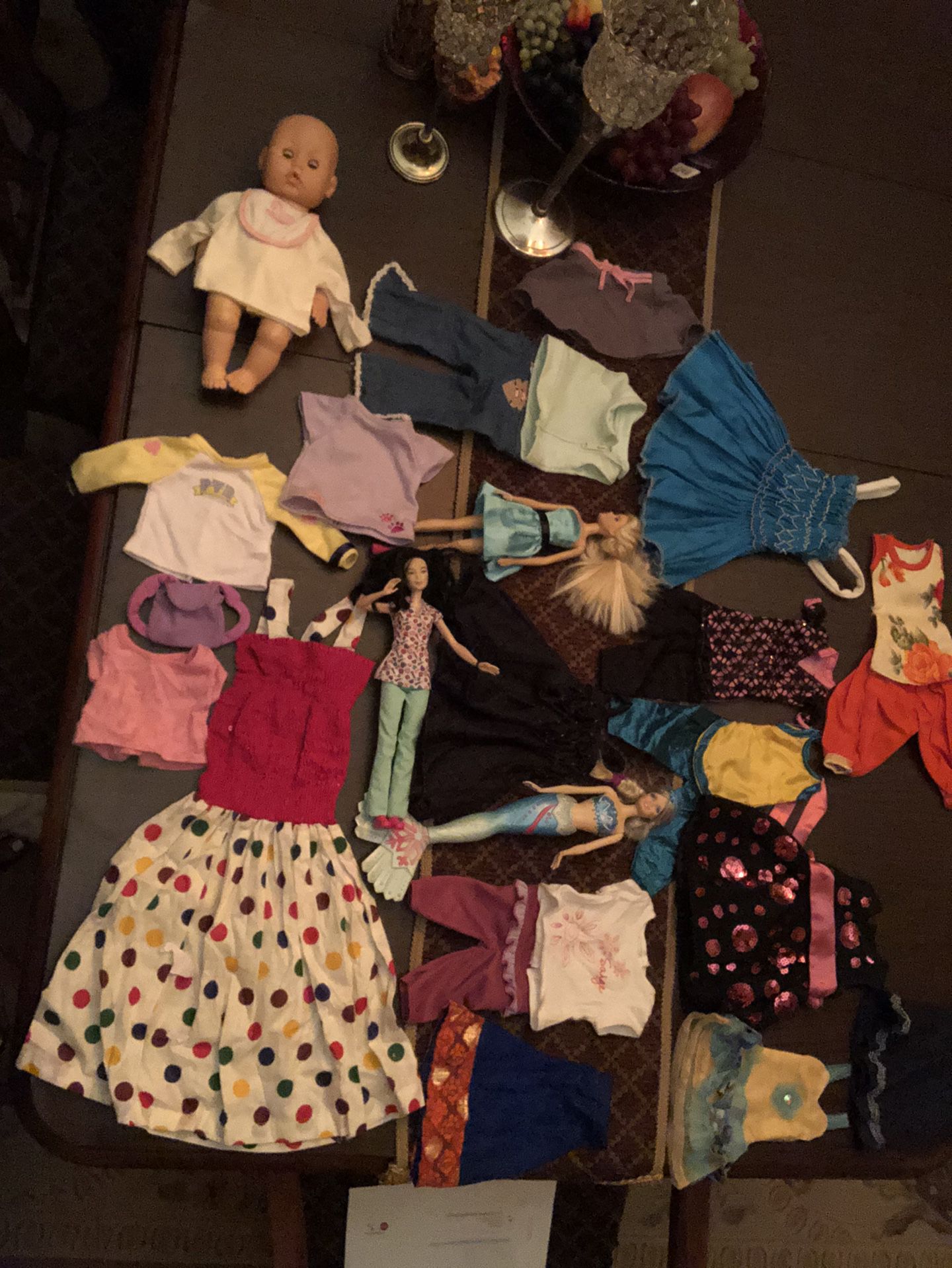 Doll clothes and 2 Barbie dolls and a baby doll
