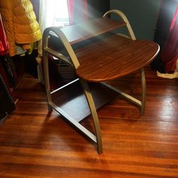 Sleek, modern design with metal frame and wood-finish surfaces