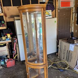 Wood corner display case with mirrored interior and overhead light