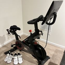 Peloton Bike (Updated Seat Post) Includes 2 pairs of Nike Cycling Shoes (men & women) and a set of 2lb weights 