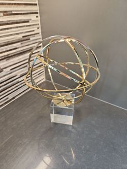 Gold orb accent on glass base