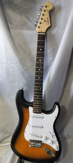 Squier by Fender electric guitar with new gig bag