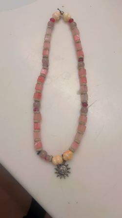 Beach themed beaded necklace with a sun pendant