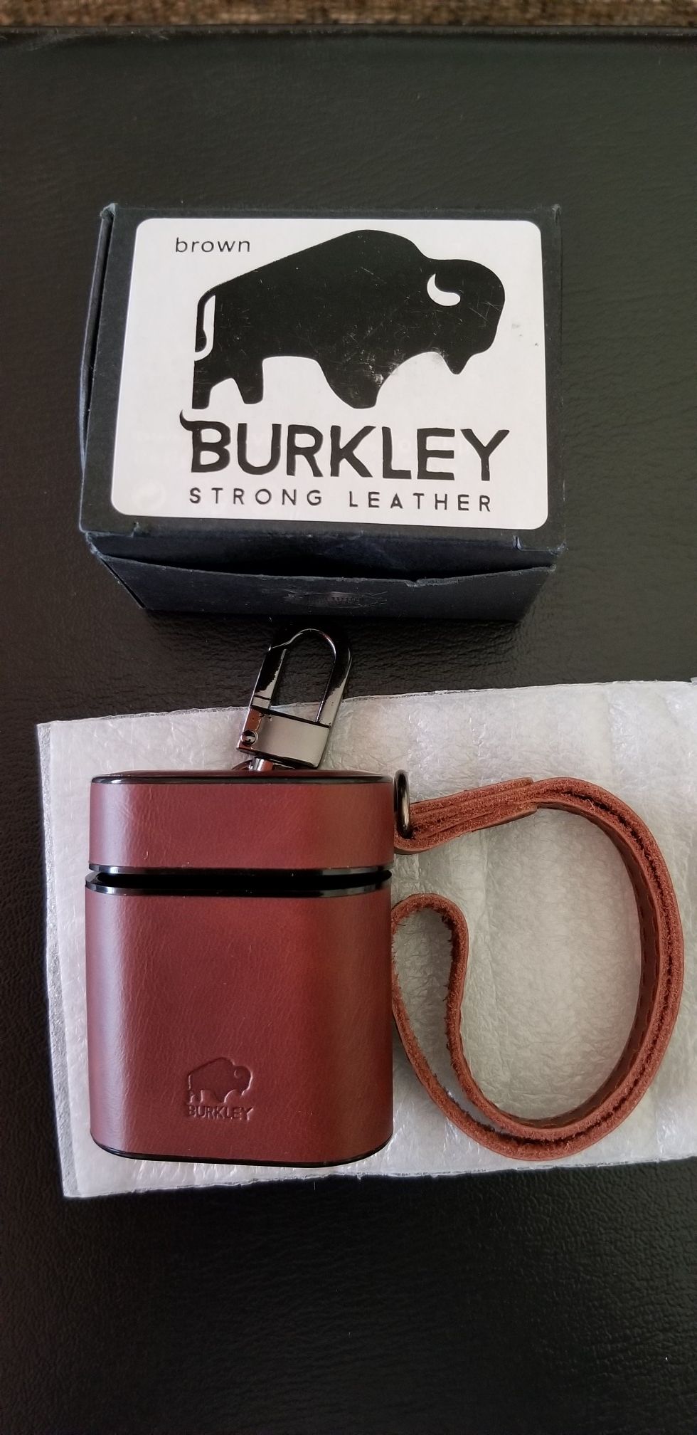 Burkley Strong Leather Case Fits Airpods 1st and 2nd Gen. No need to remove the case for charging. Hand strap included. Belt Clip Attached.
