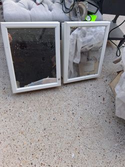 Pair of white framed medicine cabinets