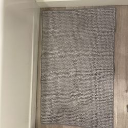 Gray textured bath mat.