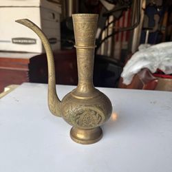 vintage or antique brass ewer, also commonly referred to as a teapot or kettle, likely originating from the Middle East or India.  