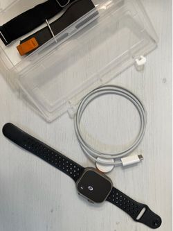 Apple Watch Ultra with Multiple Bands and Charger