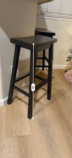 Two black wooden stools
