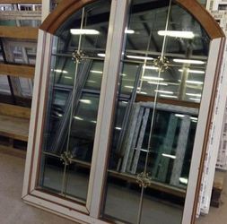 Arched Wood Frame Windows with Decorative Grilles