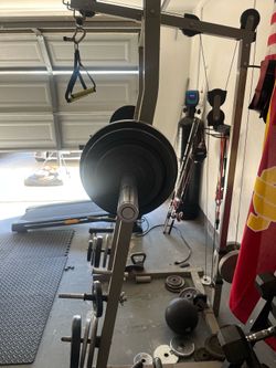 Squat rack with overhead push down pulley.