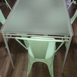 A Small Table With Four Chairs 