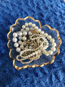 More than 15 pieces of sparkling costume jewelry and pearls.