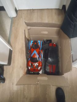 Box of 2x rc cars and remote