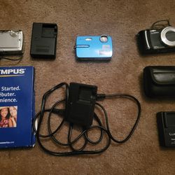 Set Of 3 Digital Cameras With Chargers (2 Olympus & 1 Lumix)