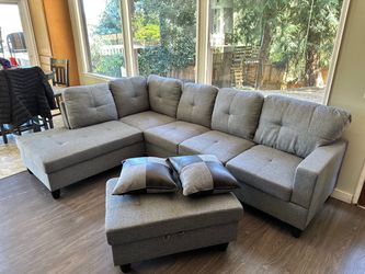 Gray linen sectional couch and ottoman