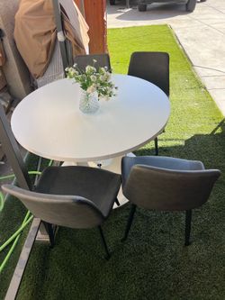 Round White Dining Table with 4 Gray Chairs