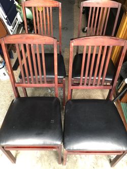 Four folding chairs with black leather cushion