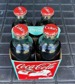 Vintage 1990's coca cola 125th anniversary four pack bottles with case unopened sealed located in palm springs ca