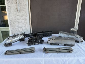 vintage Lionel postwar O gauge model trains and track, featuring a Union Pacific Diesel set (number 2023) and a United States Army locomotive. 
